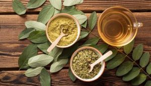 top-view-cup-tea-natural-herbs-leaves